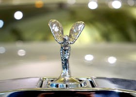 Detailed shot of a luxury car emblem reflecting the elegance and style of automobile design.